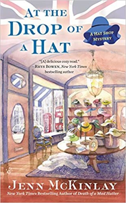 Book cover for "At the Drop of a Hat" by Jenn McKinlay