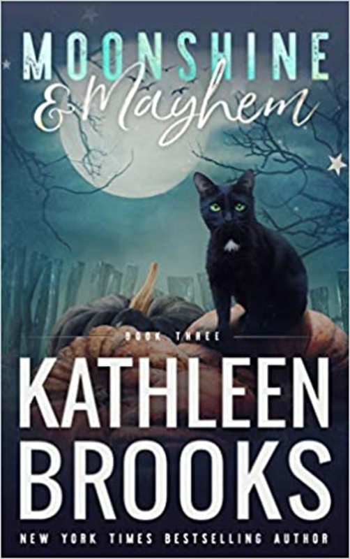 Book cover for "Moonshine & Mayhem" by Kathleen Brooks